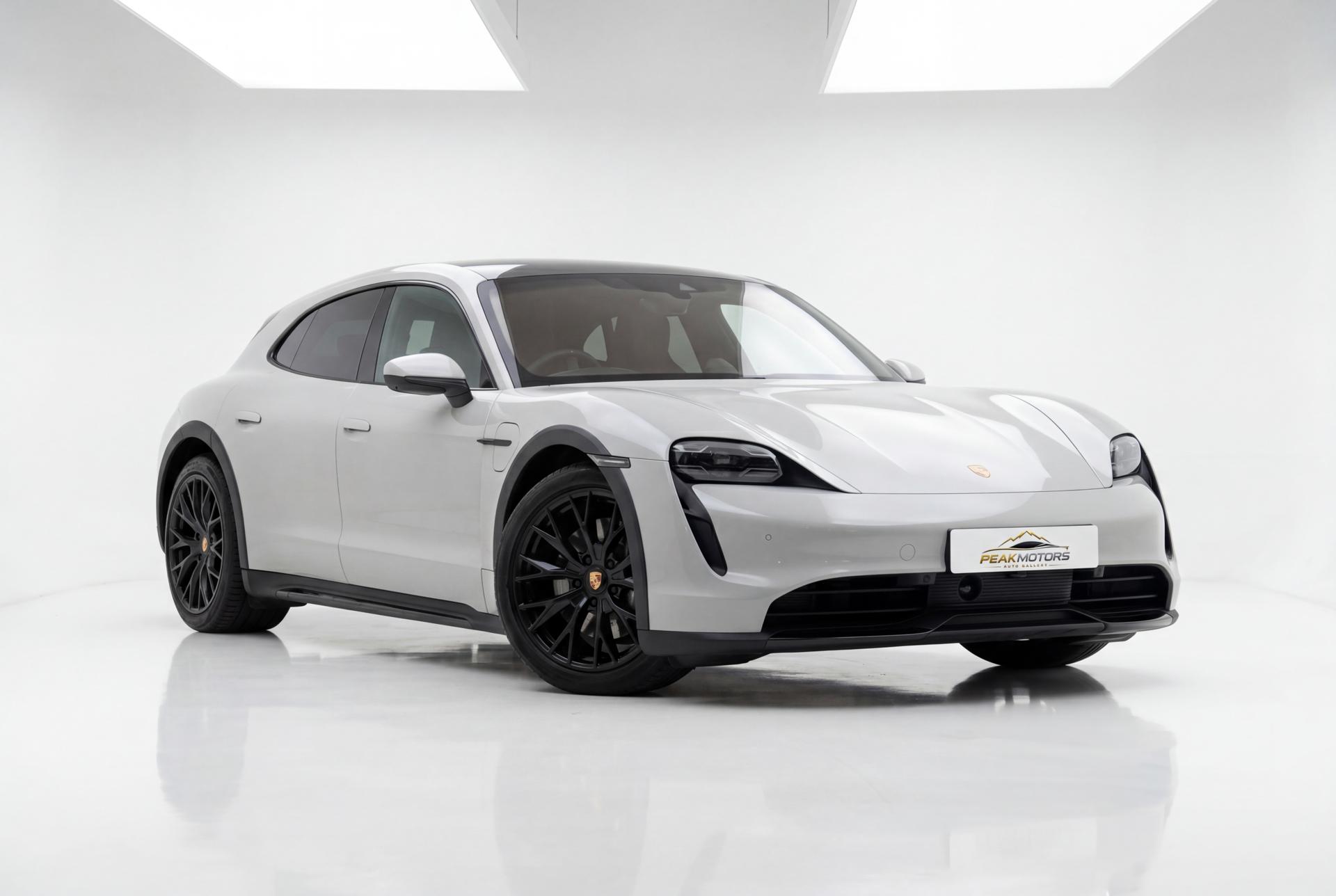 Porsche Taycan composited into a white studio showroom by PeakCar
